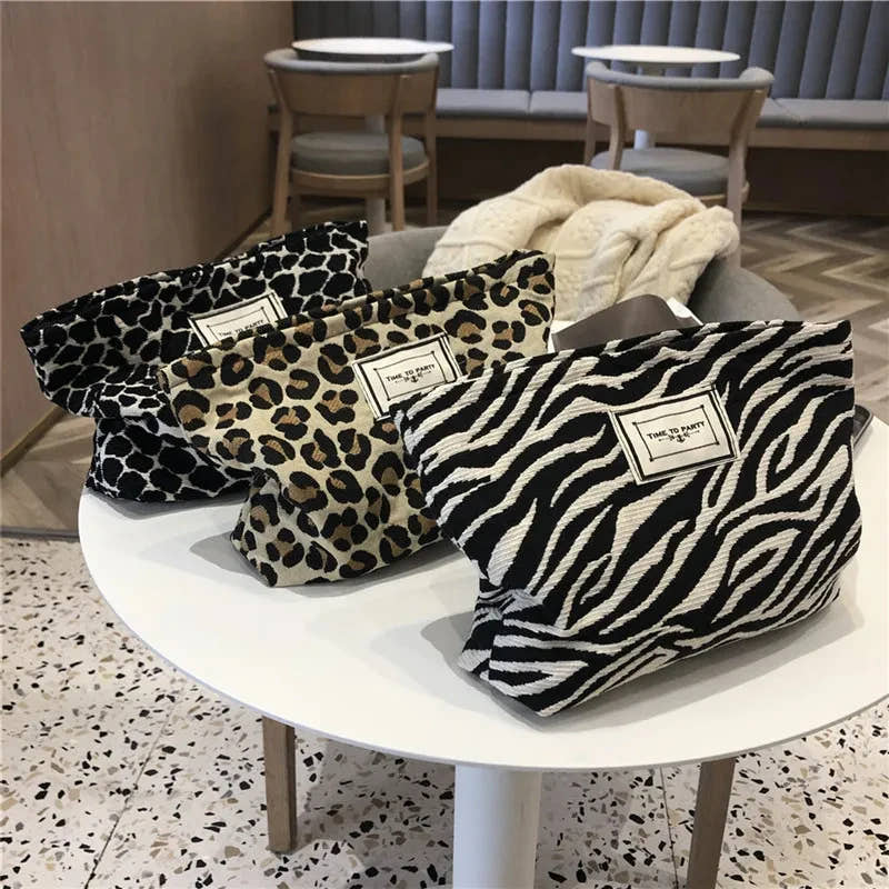 Untamed Glam animal-print knit makeup clutch bags in leopard, cheetah, and zebra print